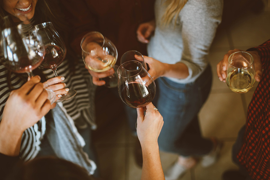 Friends toasting together with wine glasses.
